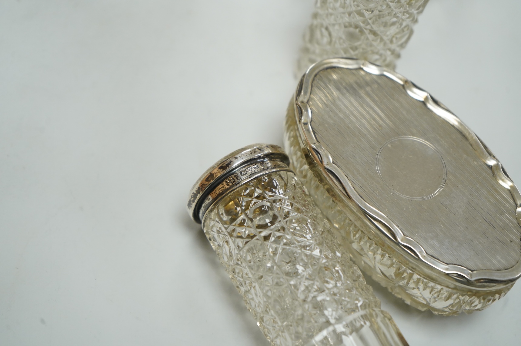 Three George V silver and tortoiseshell mounted glass toilet jars, Adie Brothers, Birmingham, 1925 & 1927, together with three other silver mounted glass toilet jars.